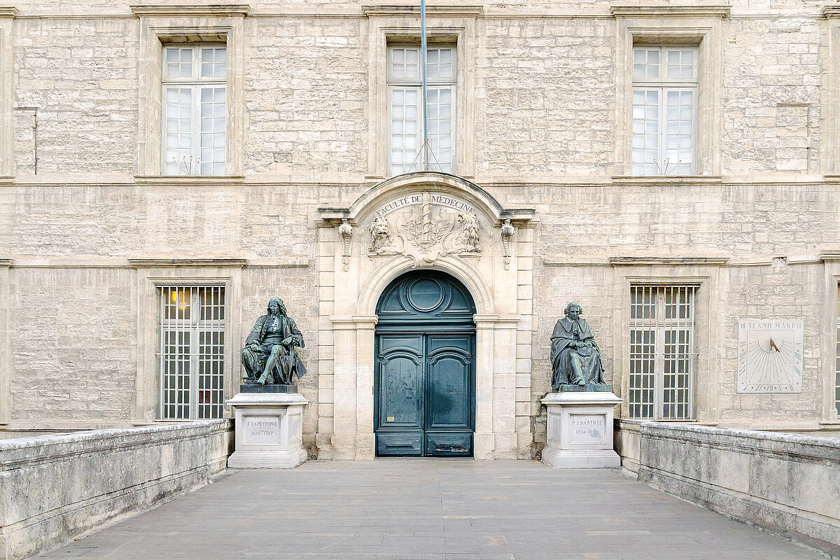 2KG4PCE View of ancient stone facade and entrance with carved pediment of oldest faculty of medicine in the world still in operation, Montpellier, France